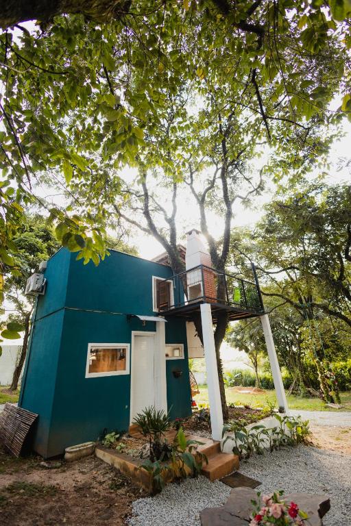 a blue house with a balcony on top of it at Minicasa Brasileira in Sorocaba