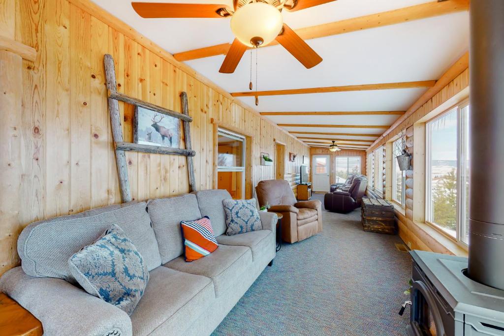 a living room with a couch and a ceiling fan at The Lake House in Polson