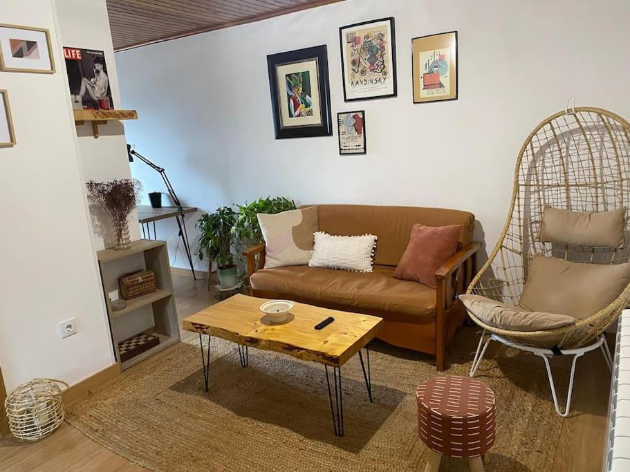 a living room with a couch and a coffee table at Casa de campo a 5 min de Vigo in Mos