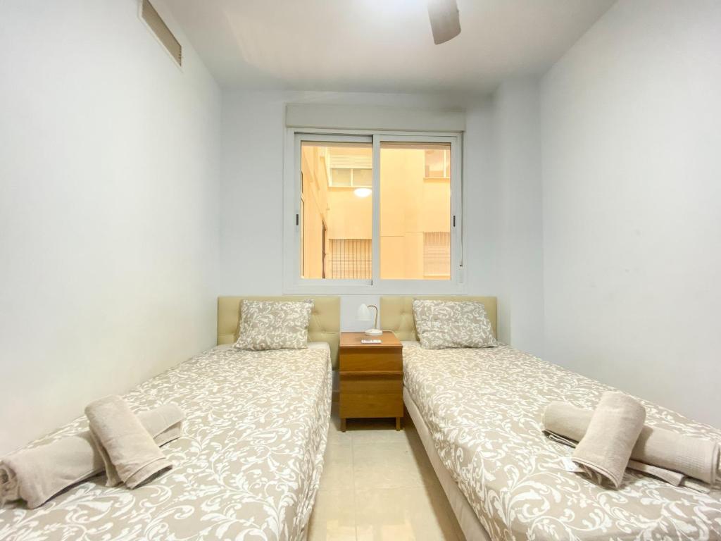 A bed or beds in a room at Great Location, Estepona Town