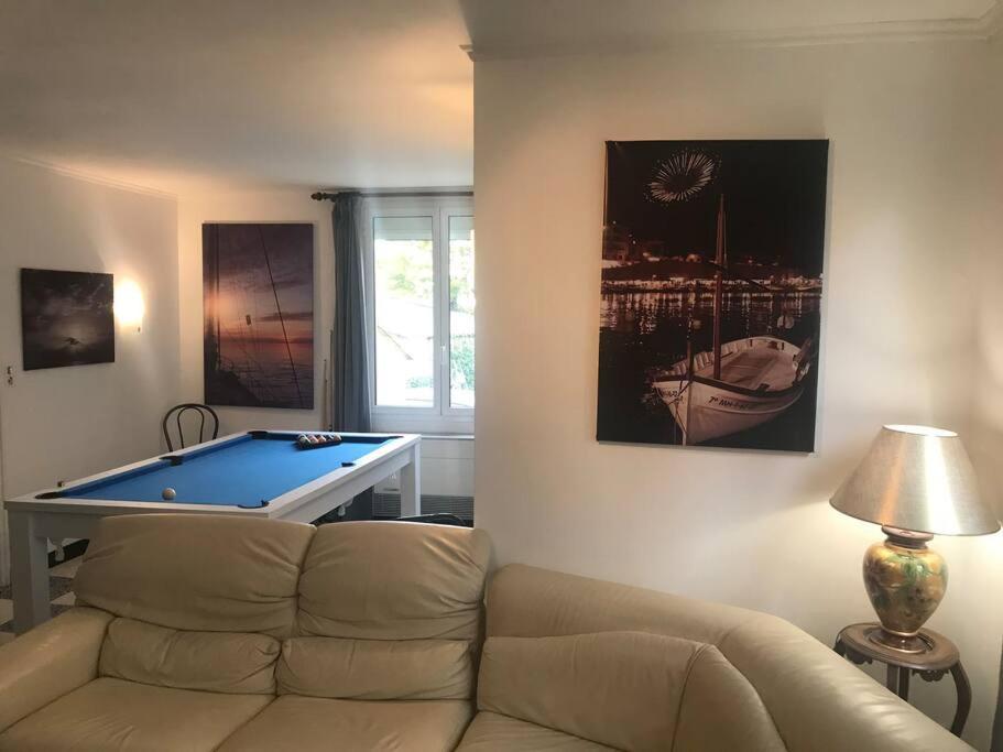a living room with a couch and a pool table at Villa, avec piscine chauffée in Servian