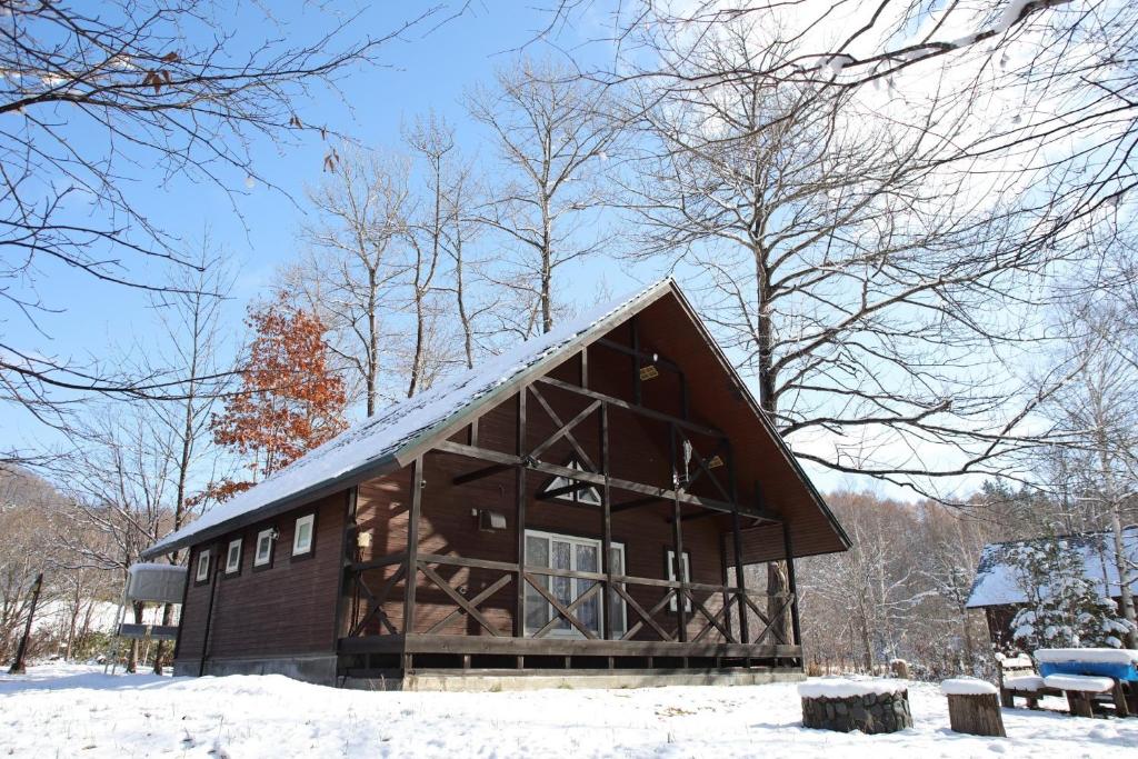 a large log cabin in the snow with trees at Esashi-gun - Cottage - Vacation STAY 38359v in Pinneshiri