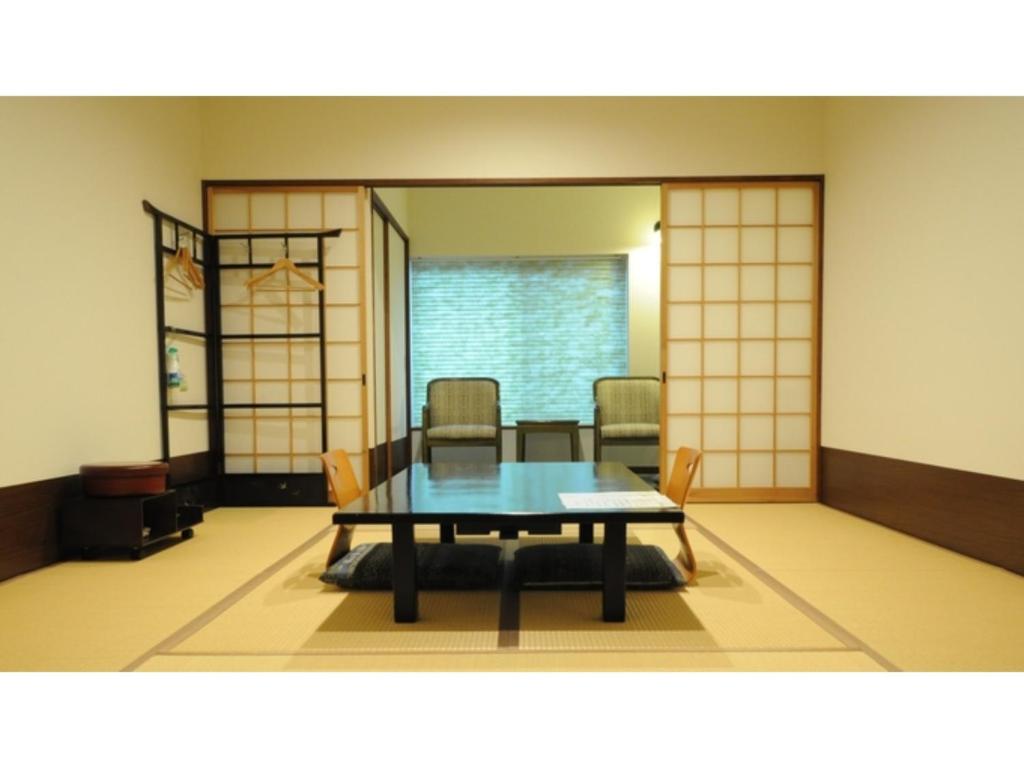 a dining room with a table and chairs at Yoro Onsen Honkan - Vacation STAY 09608v in Onomichi