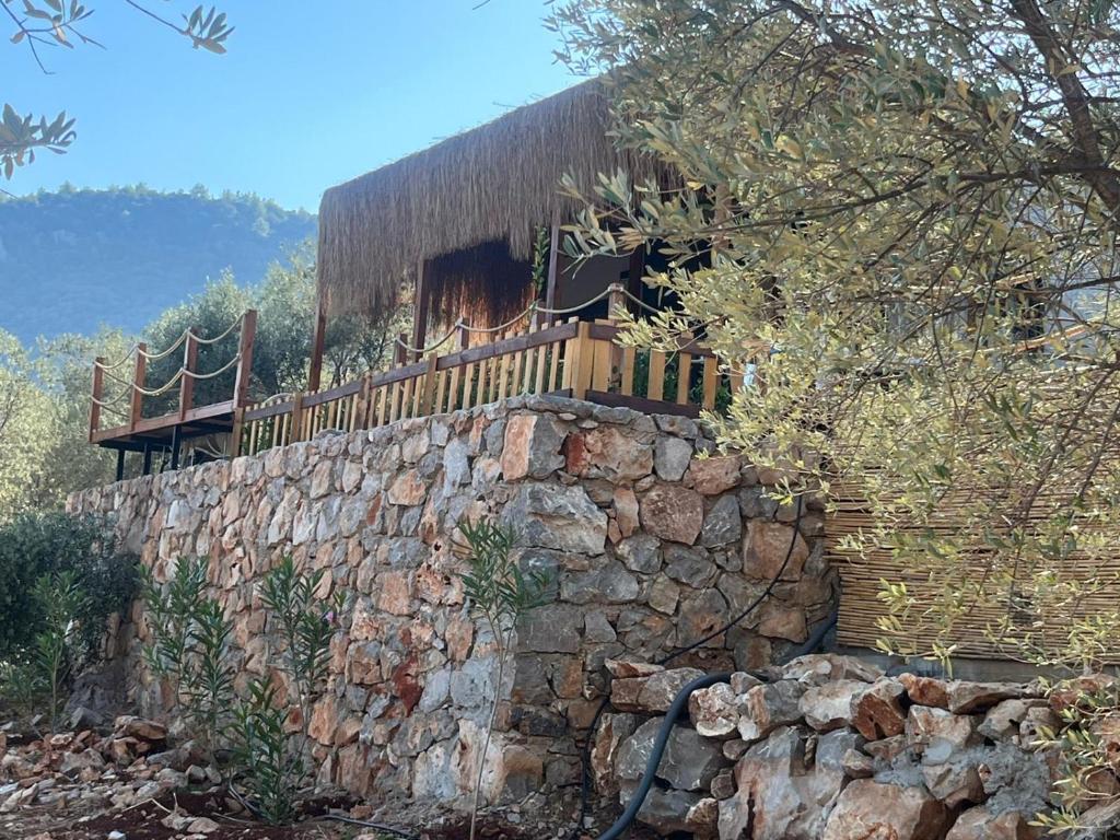 a house on top of a stone wall at Lovin Göcek Tiny House Butterfly in Gökçeovacık