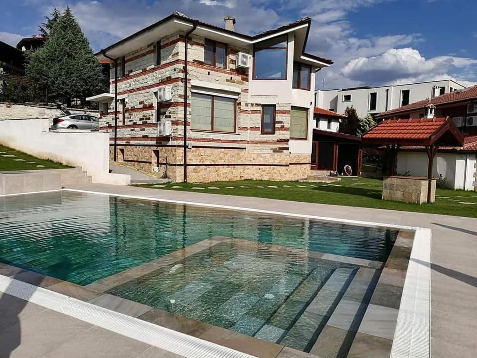 a house with a swimming pool in front of a house at Ракшиева Къща in Glavatartsi