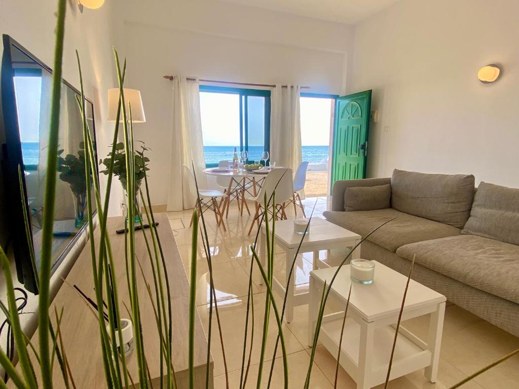 ein Wohnzimmer mit einem Sofa und einem Tisch in der Unterkunft Apartamento 11. Arena y mar in Playa Honda