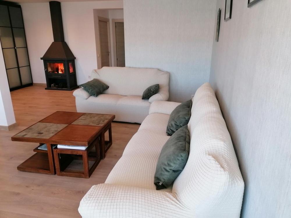 a living room with two white couches and a table at Las Vistas in Buendía