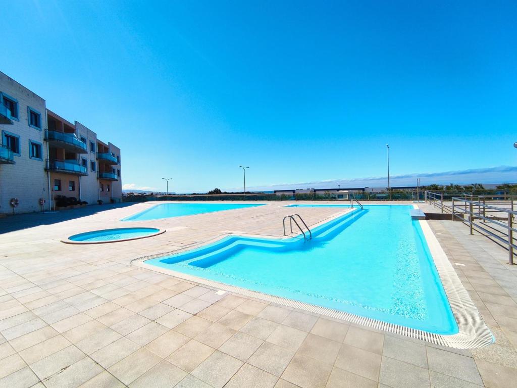 a large swimming pool in the middle of a building at Sunrise Apartmento Ribeira d'Ilhas Ericeira in Ericeira