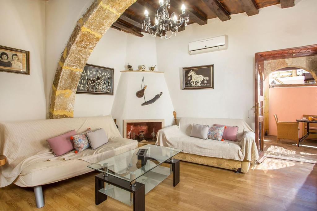 a living room with two couches and a fireplace at Fotini's House in Lachania