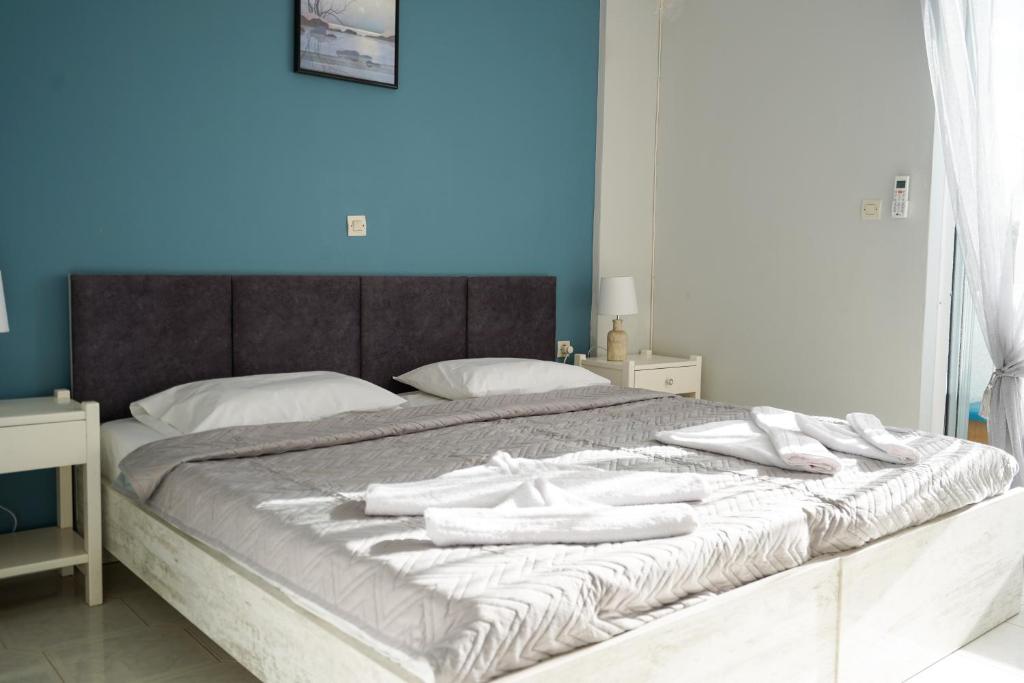 un letto con asciugamani bianchi sopra di Amvrosia Apartments a Mastichárion