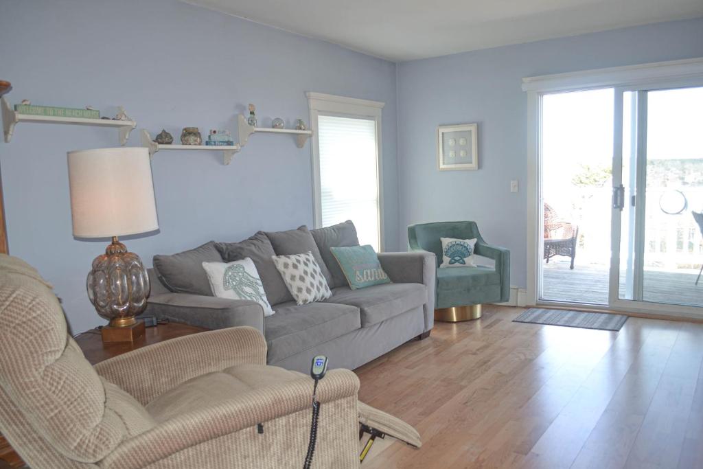 a living room with a couch and two chairs at The Lookout #210 in Ogunquit