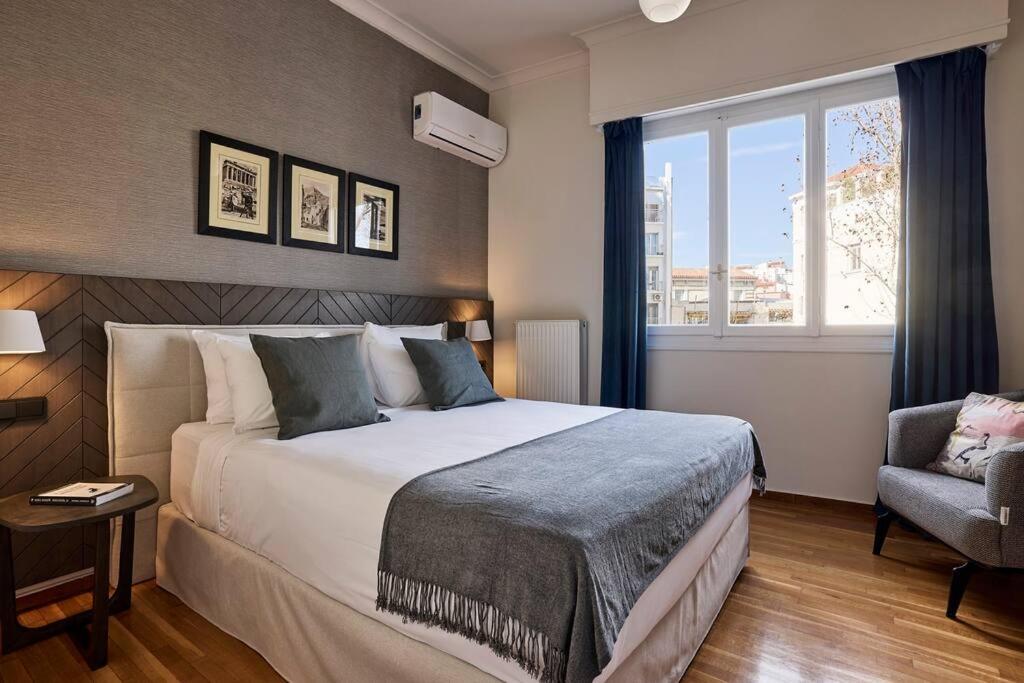 A bed or beds in a room at Acropolis Museum Grand Residence