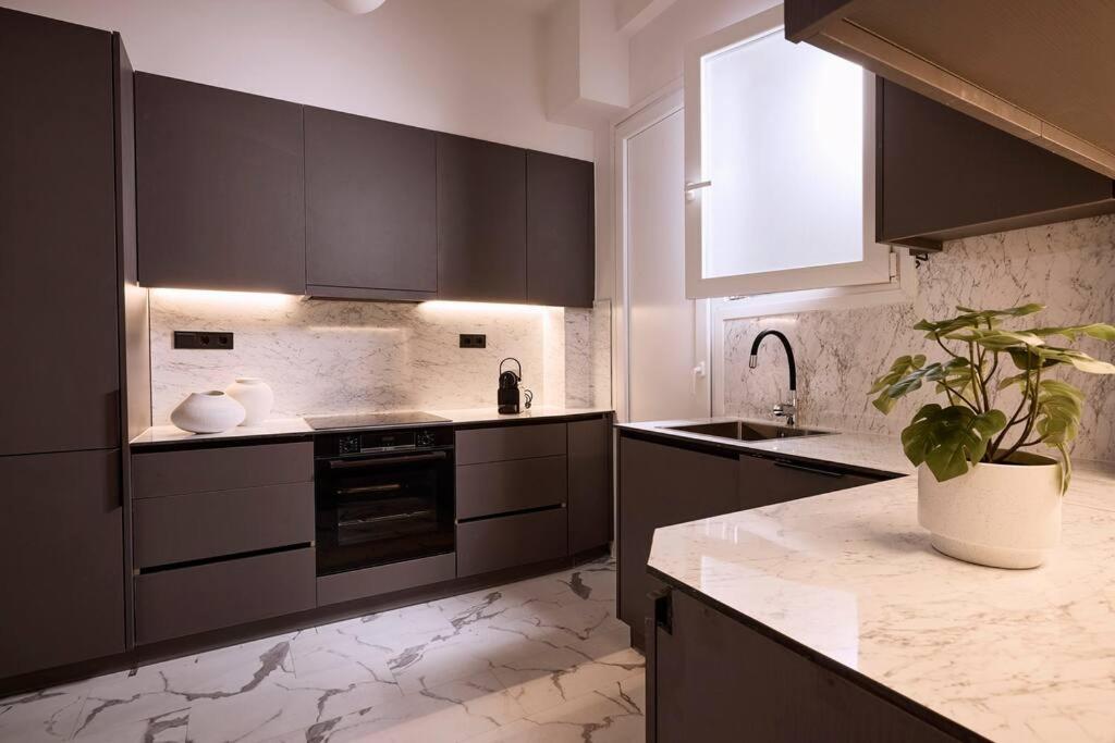 A kitchen or kitchenette at Acropolis Museum Grand Residence