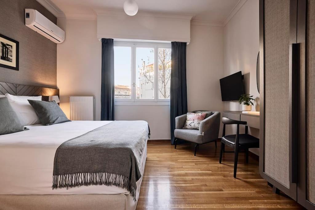A bed or beds in a room at Acropolis Museum Grand Residence