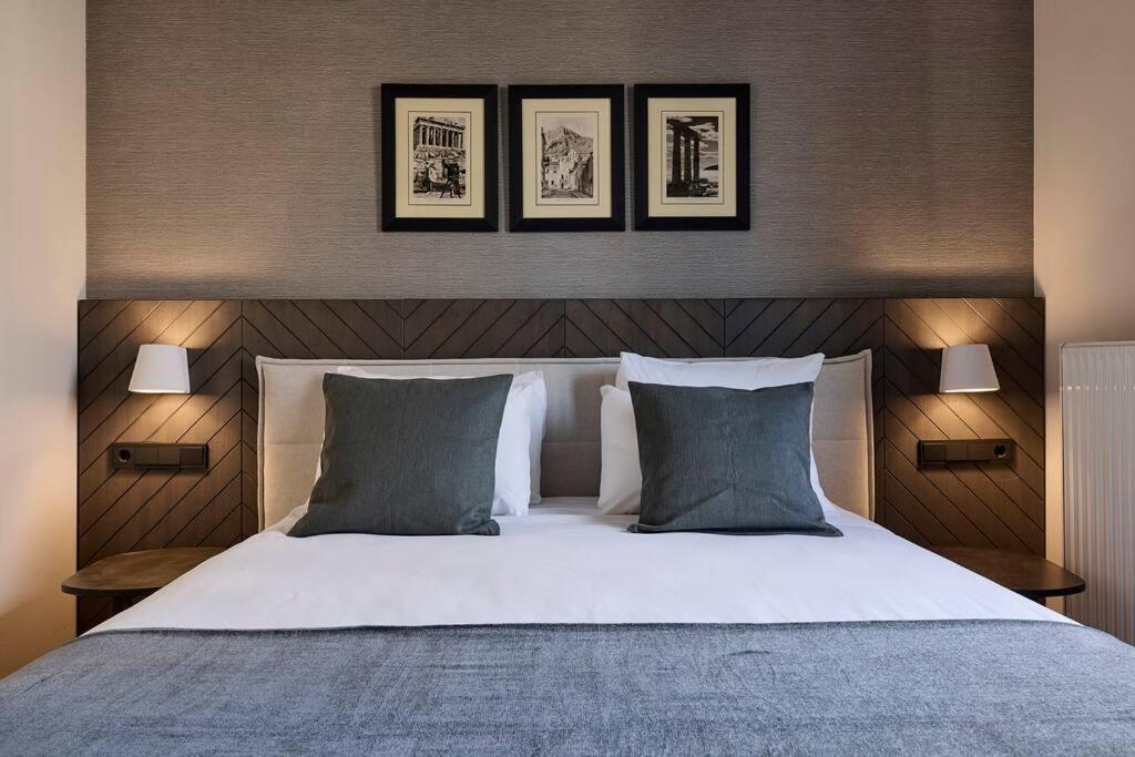 A bed or beds in a room at Acropolis Museum Grand Residence