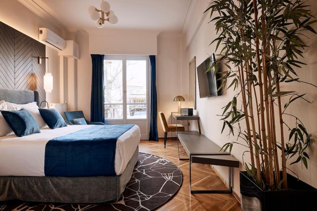 A bed or beds in a room at Acropolis Museum Grand Residence