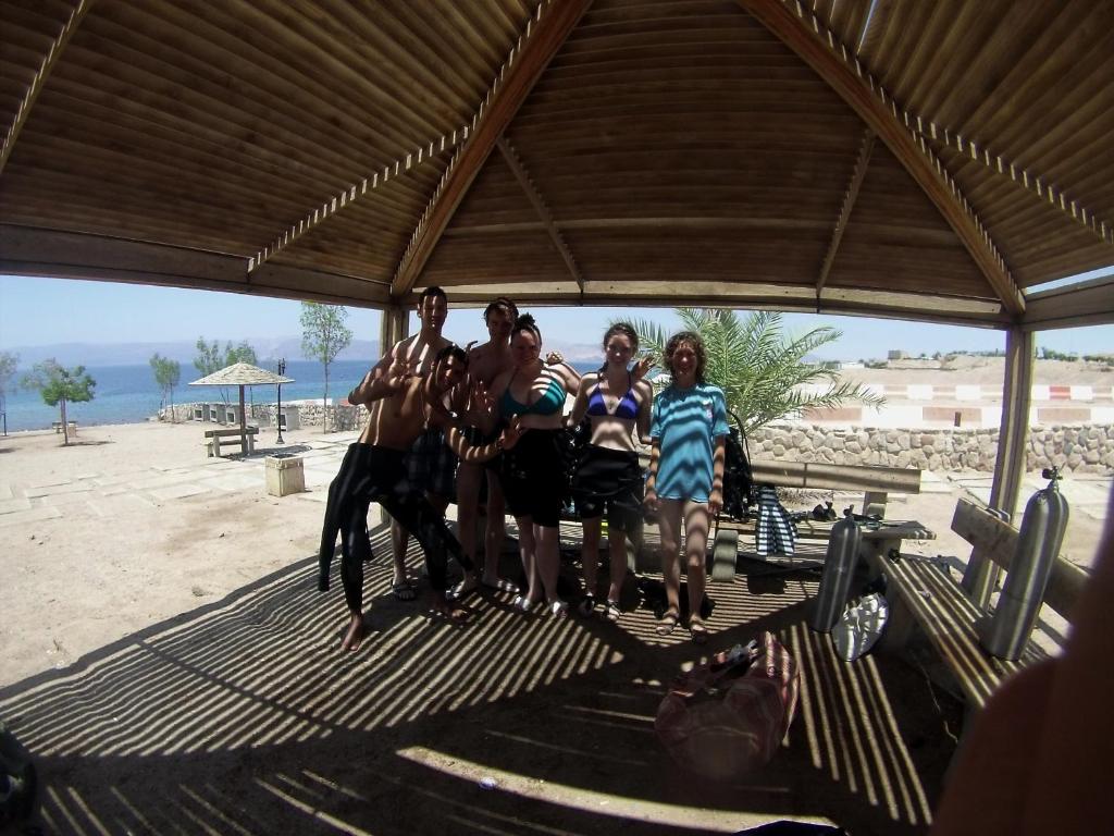 a group of people posing for a picture on the beach at Arab Divers Dive Center and Bed & Breakfast in Aqaba