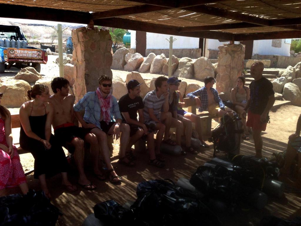 a group of young people sitting on a bench at Arab Divers Dive Center and Bed & Breakfast in Aqaba