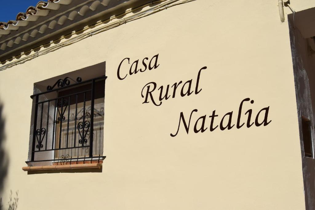 a sign on the side of a building with a window at Casa Rural Natalia in Valmuel