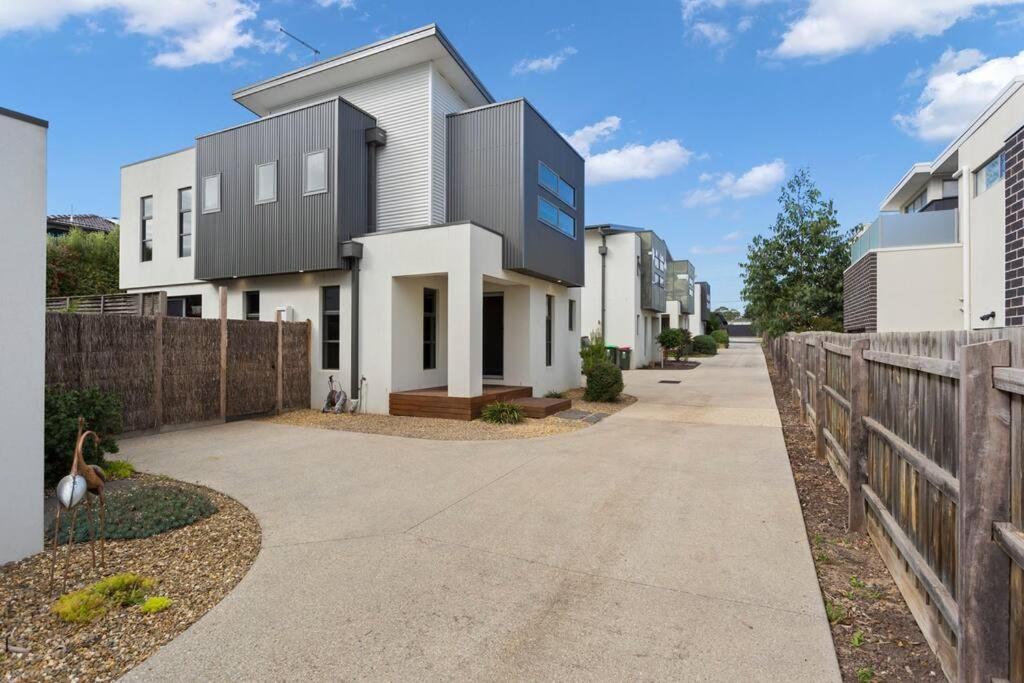 a white house with a black roof at Stunning Luxury Townhome Walk to Beach & Shops in Cowes