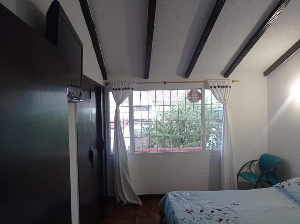 Postel nebo postele na pokoji v ubytování Hotel Bogotá Calle 100