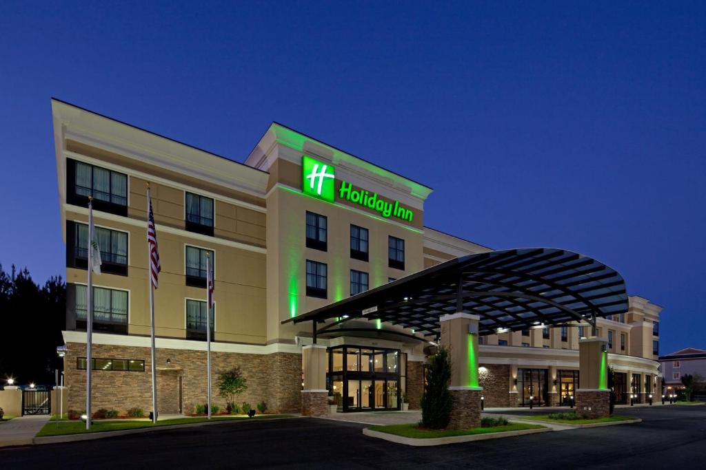 a hotel with a sign on the front of it at Holiday Inn Mobile Airport, an IHG Hotel in Mobile