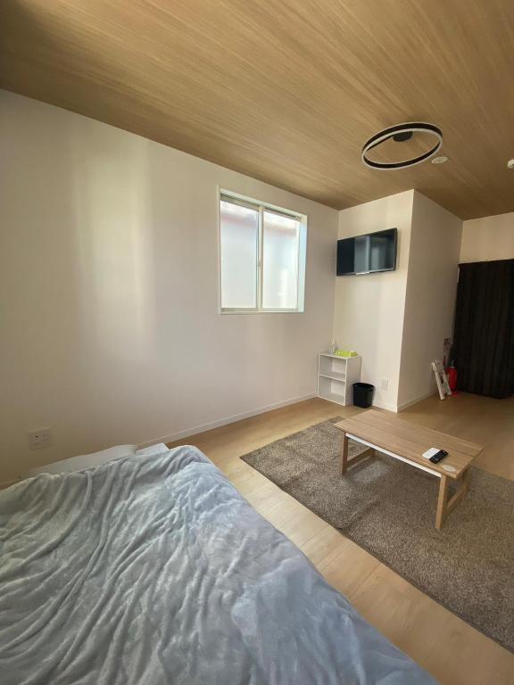 Postel nebo postele na pokoji v ubytování Guest House DARUMA