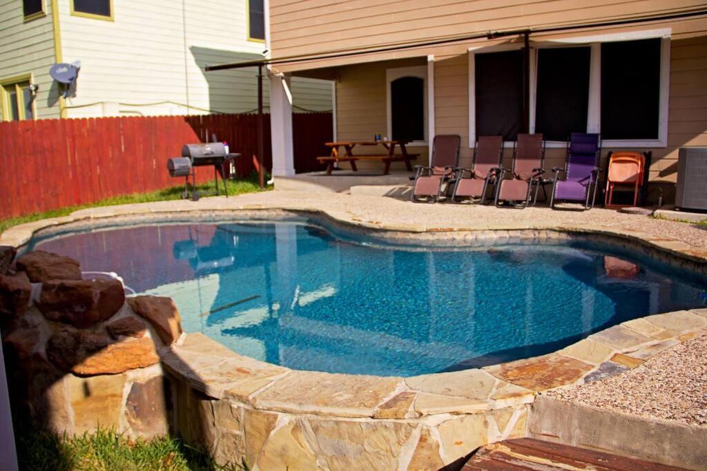 a small swimming pool with chairs in a yard at Home Away From Home (w/ Pool) in San Antonio