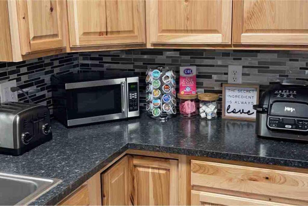 a kitchen counter with a microwave and a toaster oven at Spacious 3 BD Close To Everything! You’ll Love It! in Anchorage