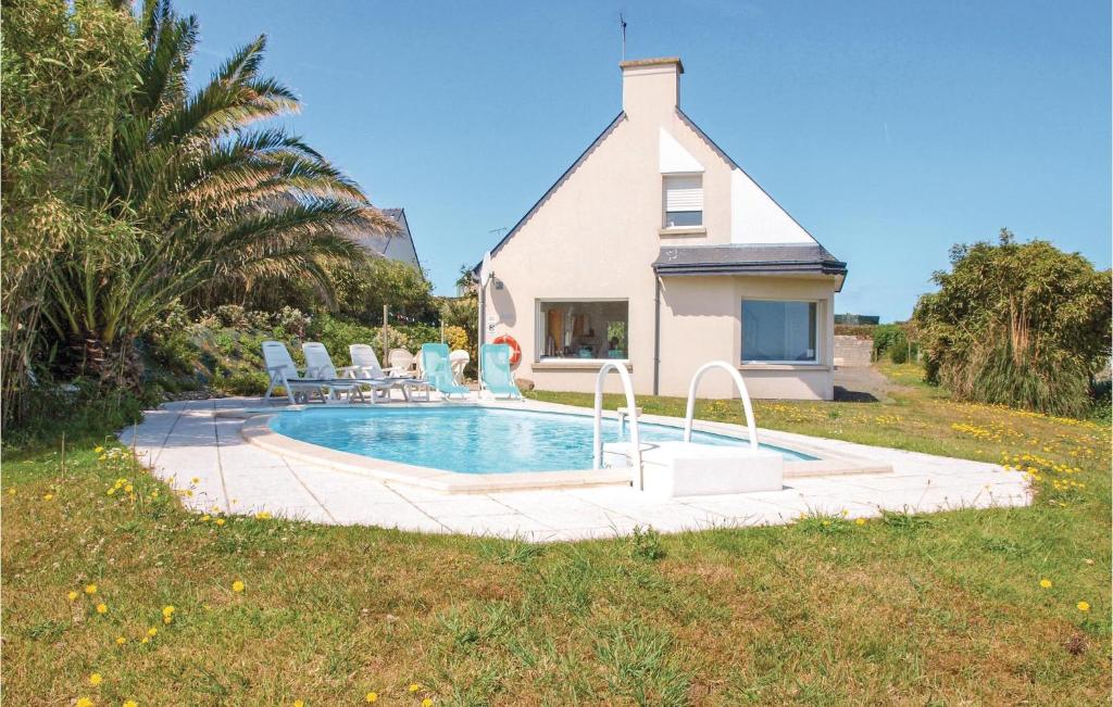 a house with a swimming pool in front of a house at Amazing Home In Pleubian in Pleubian