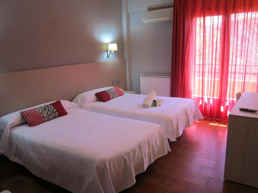 Postel nebo postele na pokoji v ubytování Hotel Meson de L’Ainsa