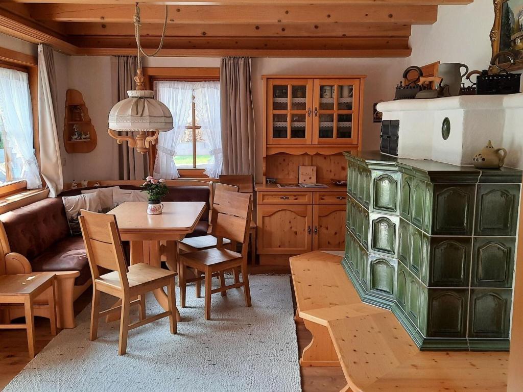 a living room with a table and a kitchen at holiday home, Krimml in Krimml