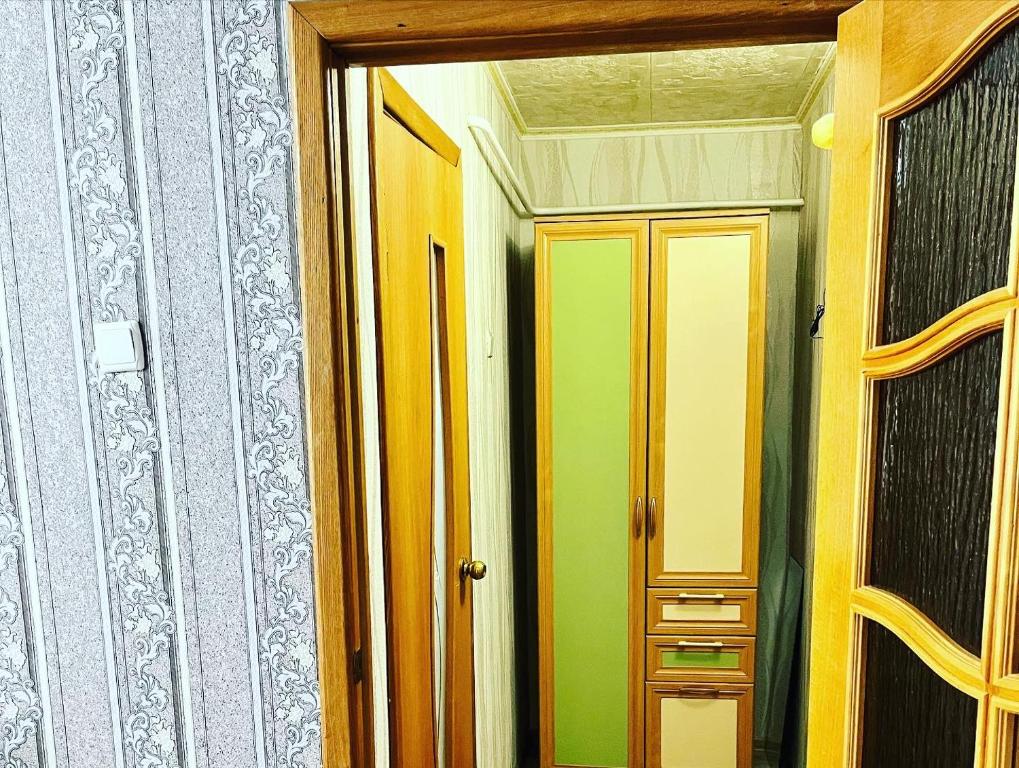 a room with a door and a mirror in it at Однокомнатная квартира Авангард 2 in Atyrau