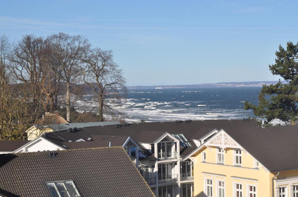 a view of the ocean from the roofs of houses at Meerblick Apartment in Göhren