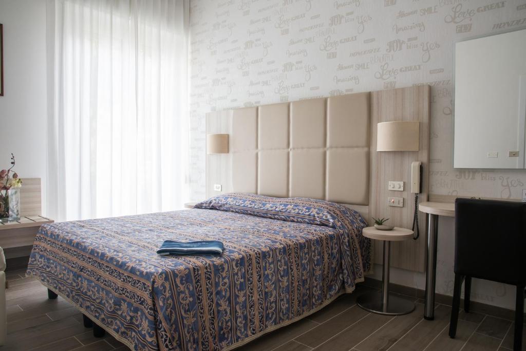 Postel nebo postele na pokoji v ubytování Hotel Gabriella