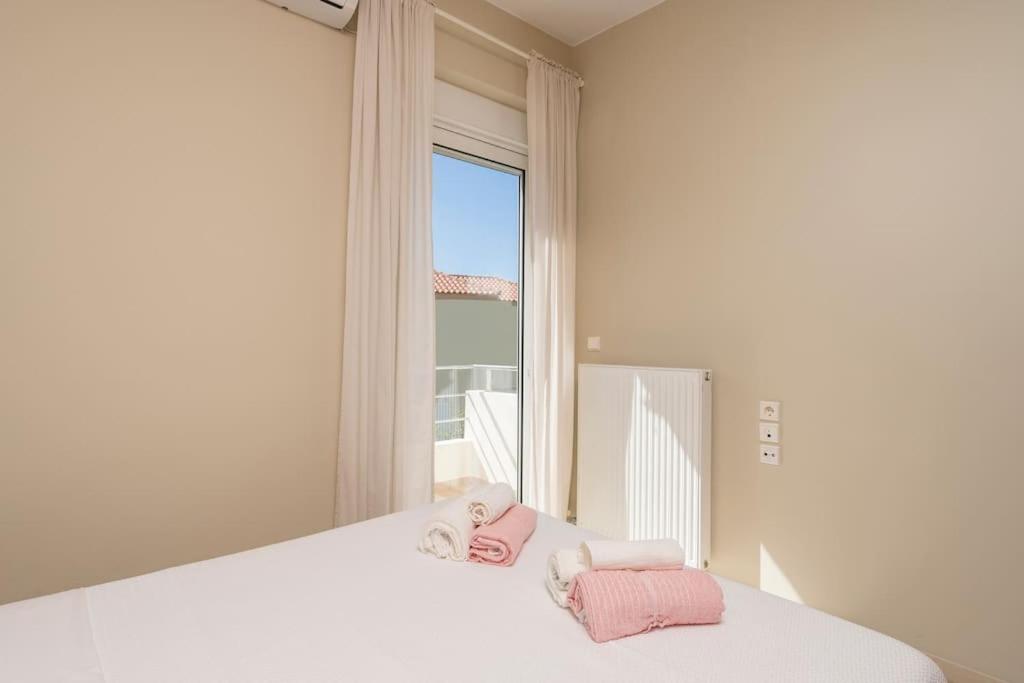 A bed or beds in a room at Charilena's luxury apartment
