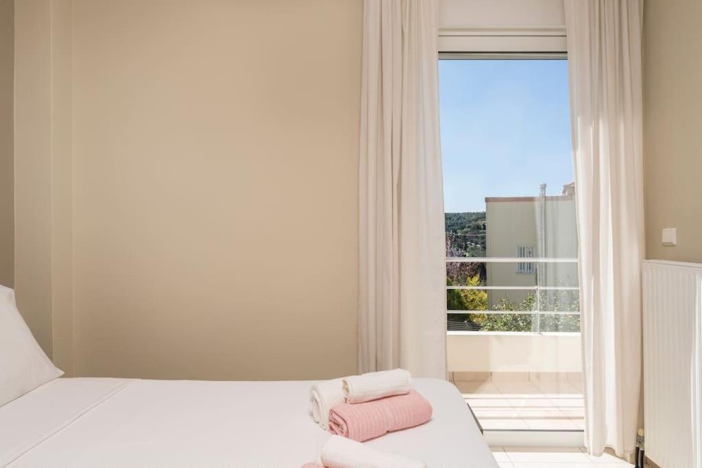 A bed or beds in a room at Charilena's luxury apartment