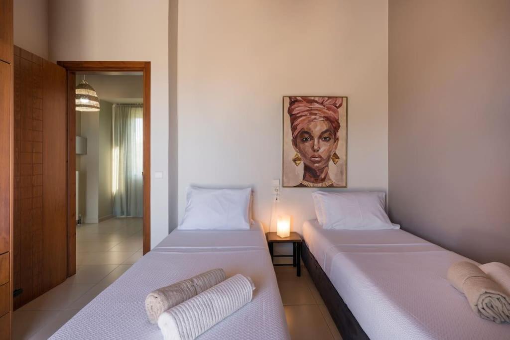 A bed or beds in a room at Charilena's luxury apartment