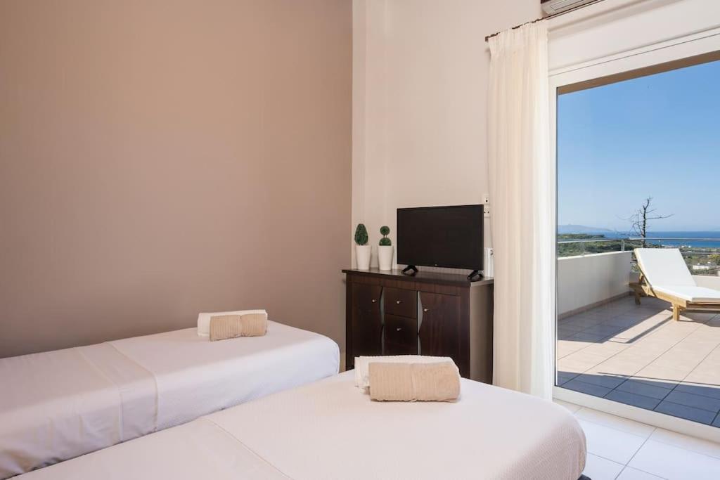 A bed or beds in a room at Charilena's luxury apartment