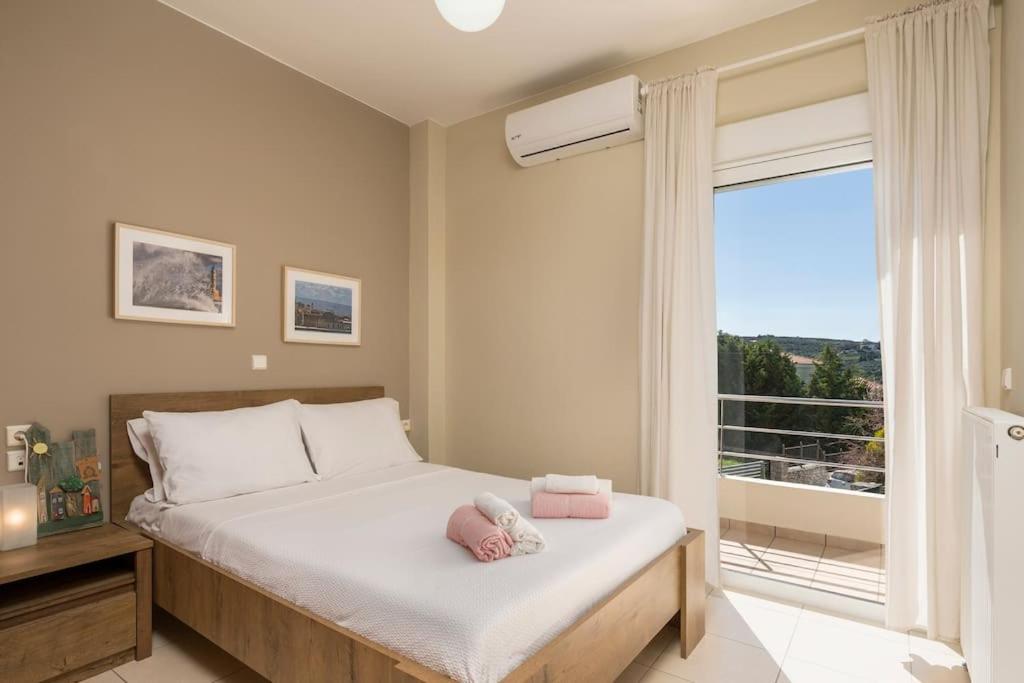 A bed or beds in a room at Charilena's luxury apartment