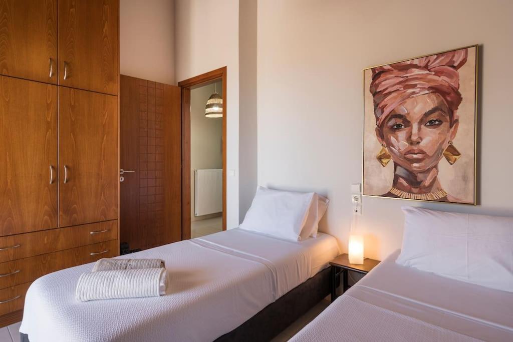 A bed or beds in a room at Charilena's luxury apartment
