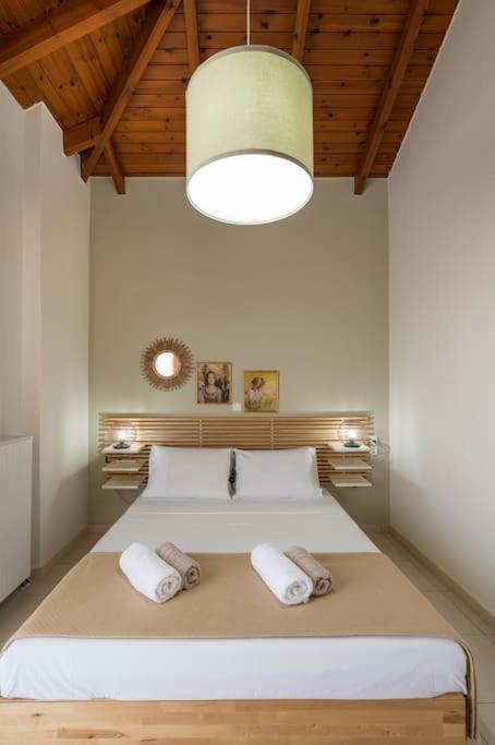 A bed or beds in a room at Charilena's luxury apartment