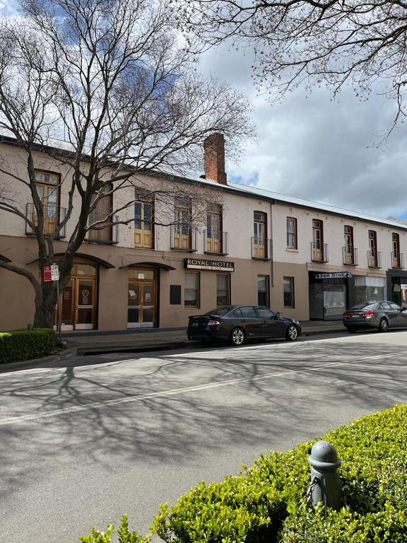 a large building with cars parked in front of it at Royal Hotel - Accommodation only in Parkes