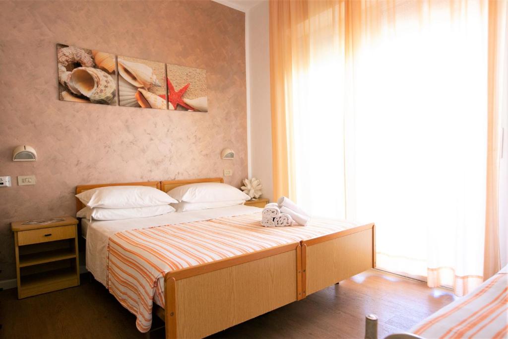 Un pat sau paturi într-o cameră la Hotel Villa Gioiosa