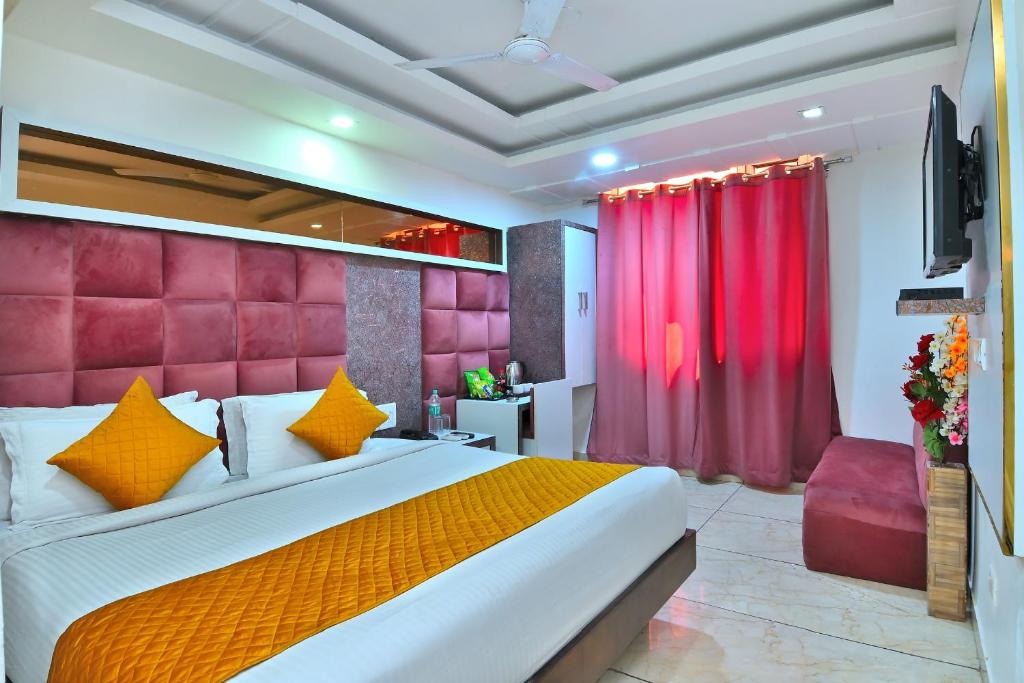 a bedroom with a large bed and a red headboard at The Bella Vista -Traveler's choice awarded in New Delhi