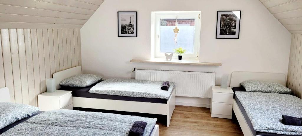 a bedroom with two beds and a window at Modern Apartment Bedburg-Hau in Bedburg Hau