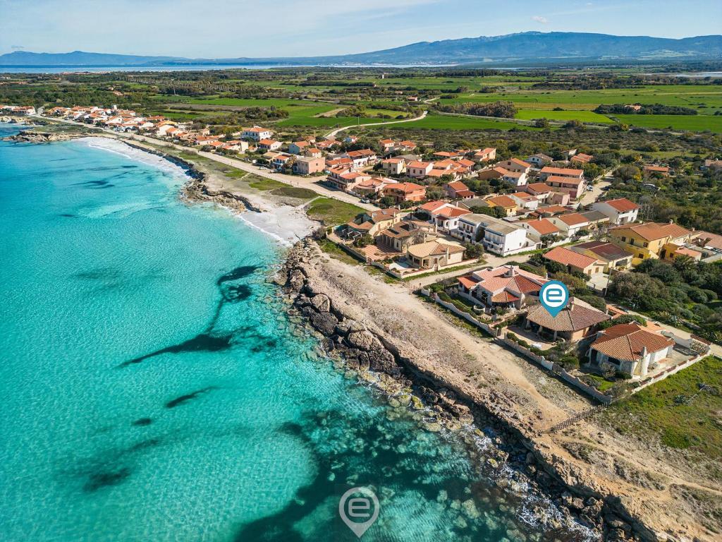 an aerial view of a resort on the beach at Seafront Rustic Hideaway in San Vero Milis