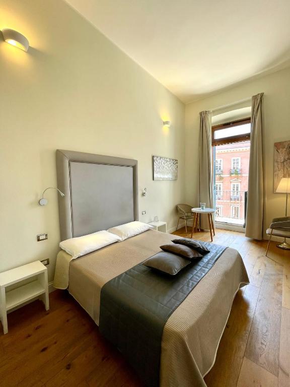 A bed or beds in a room at Antico Corso Charme