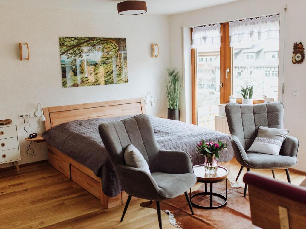 sypialnia z 2 krzesłami i łóżkiem w obiekcie Finkenstüble w mieście Sankt Peter