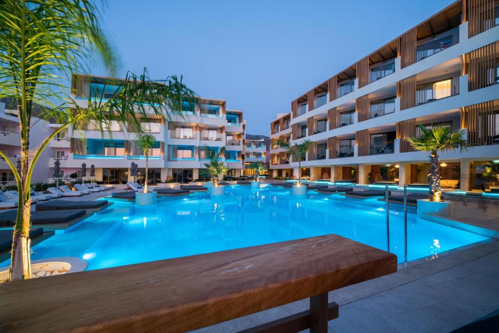 a large swimming pool in front of a building at AKASHA Beach Hotel & Spa in Hersonissos